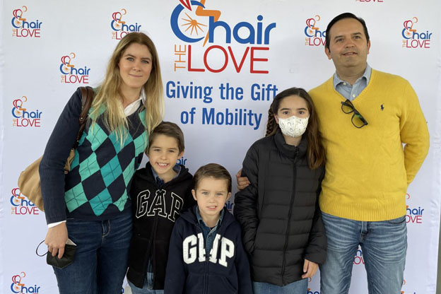 family in front of a chair the love backdrop