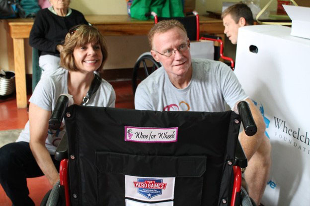 people posing with a Chair The Love wheelchair