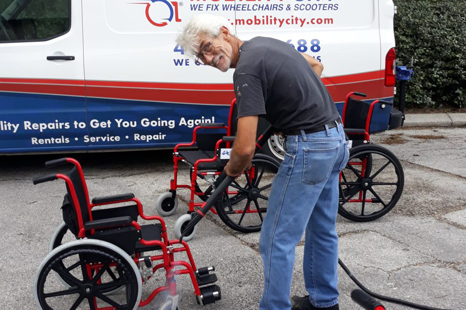 Volunteer cleaning a wheelchair