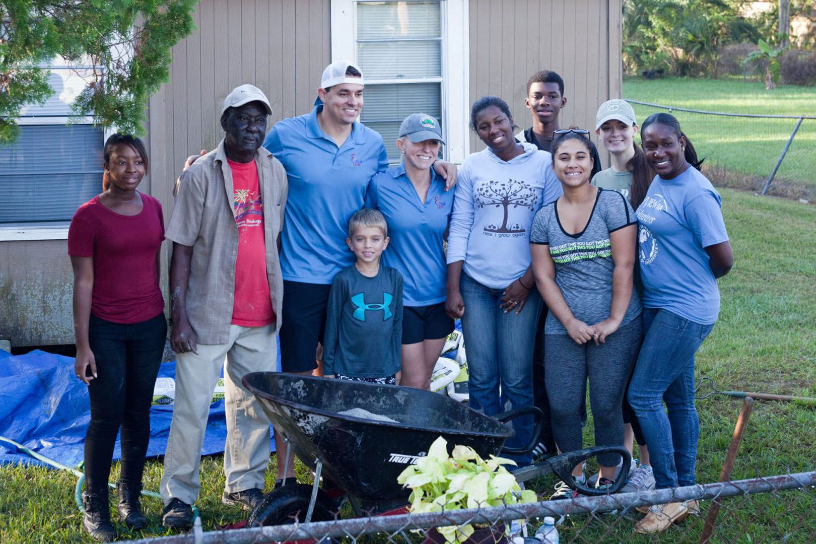 Volunteers taking a picture with a family