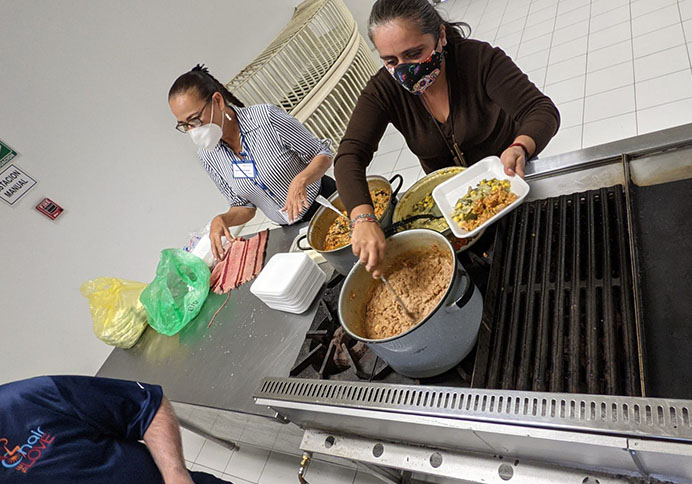 volunteers scooping out food